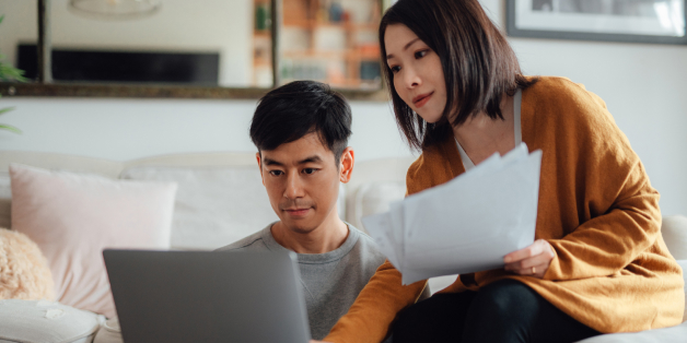Two people reviewing a bill together on a laptop